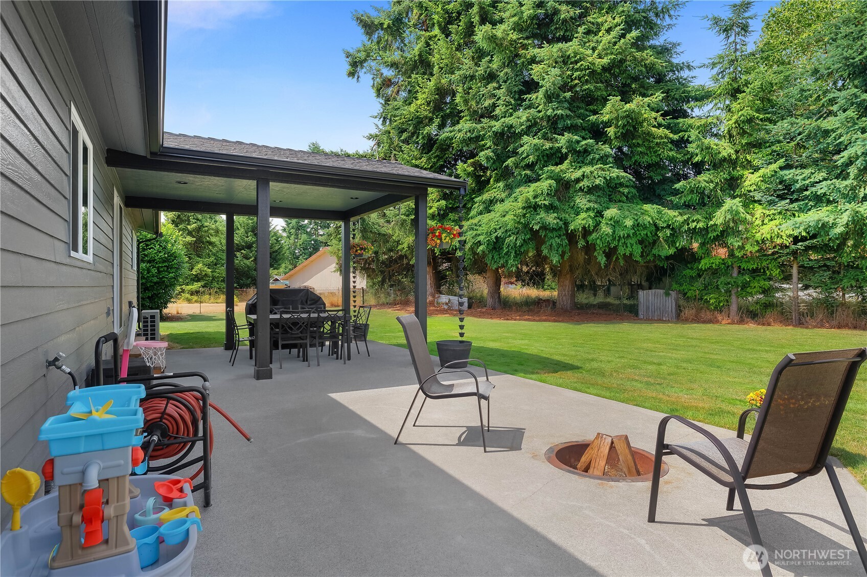 8336 178th Avenue Southwest Rochester, WA 98579 - Photo 30 of 39 a backyard of a house with table and chairs