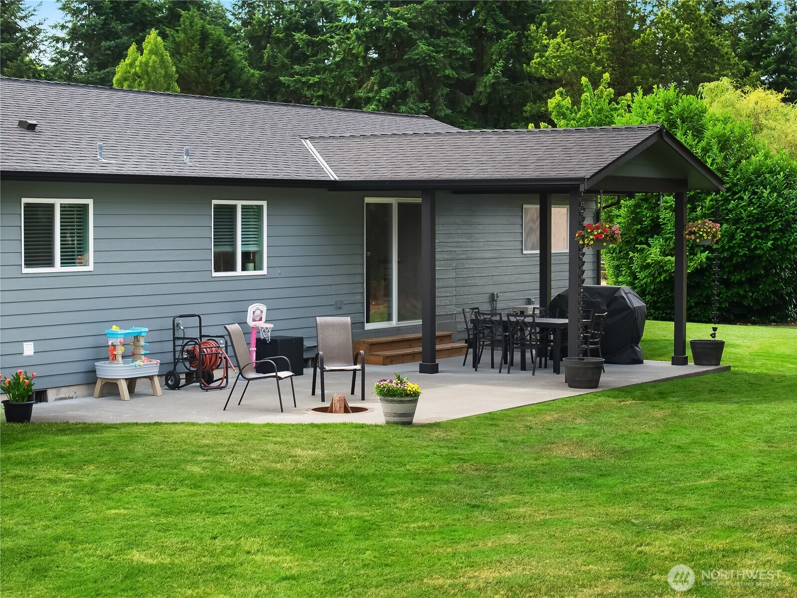 8336 178th Avenue Southwest Rochester, WA 98579 - Photo 31 of 39 a view of a chairs and table in patio next to a yard