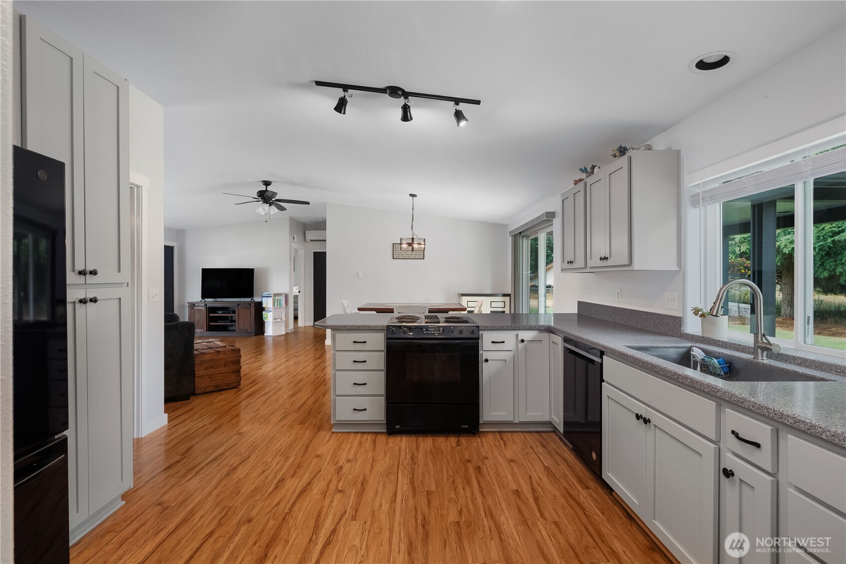 8336 178th Avenue Southwest Rochester, WA 98579 - Photo 10 of 39 a kitchen with stainless steel appliances granite countertop hardwood floor sink stove and wooden cabinets