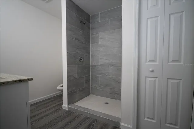 a bathroom with a shower and a sink