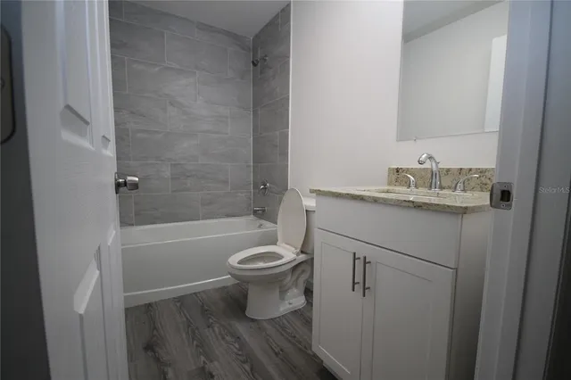 a bathroom with a sink a toilet and bathtub