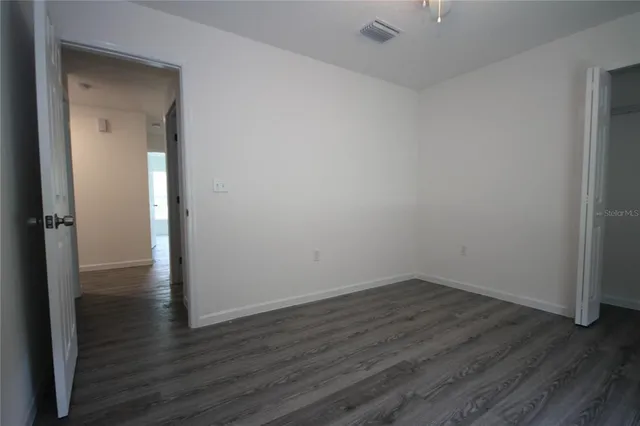 a view of a room with wooden floor