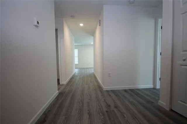 a view of a room with wooden floor