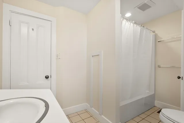 a bathroom with a toilet a sink and shower