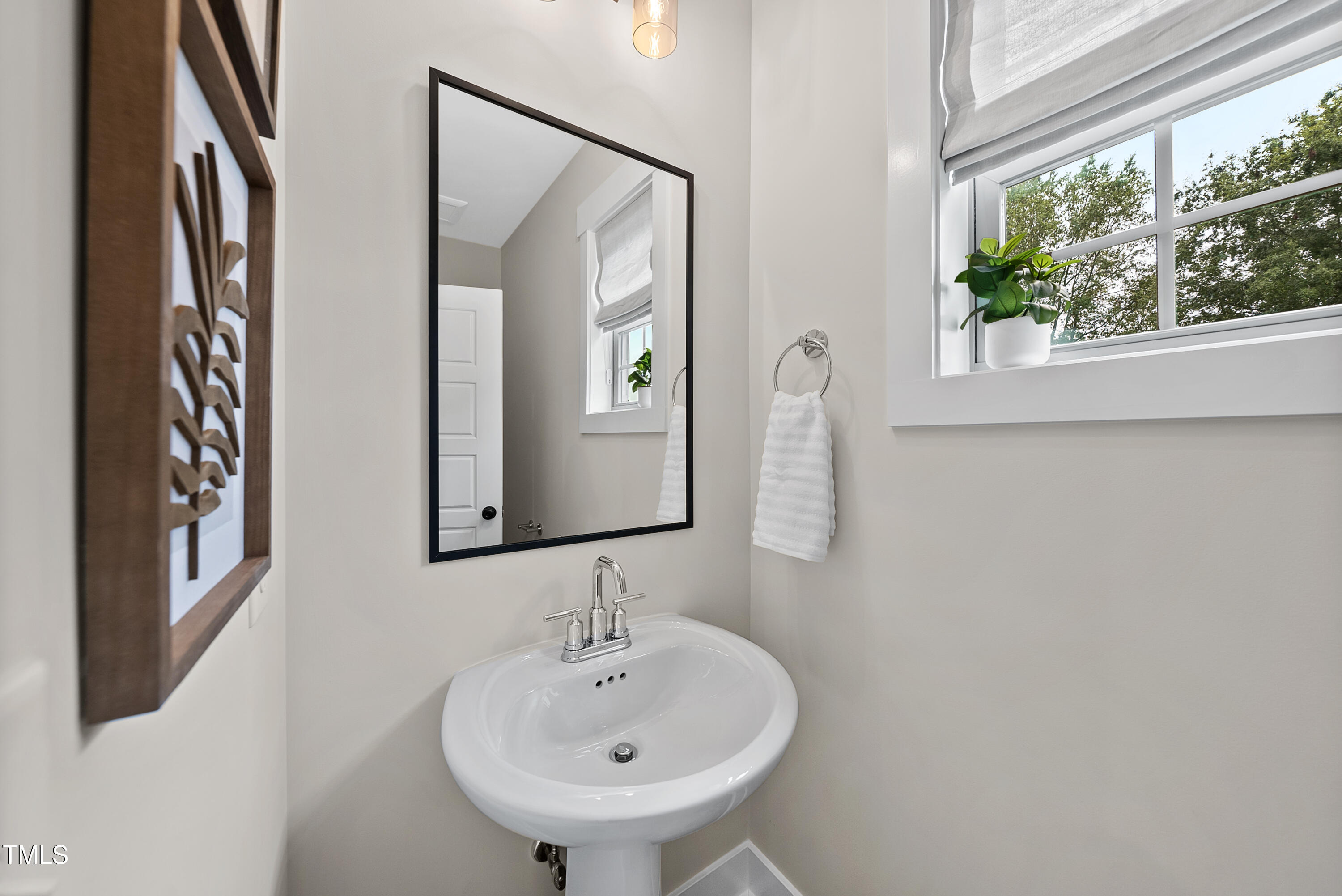 1049 Coldspring Circle Durham, NC 27705 - Photo 14 of 23 a bathroom with a sink and a mirror