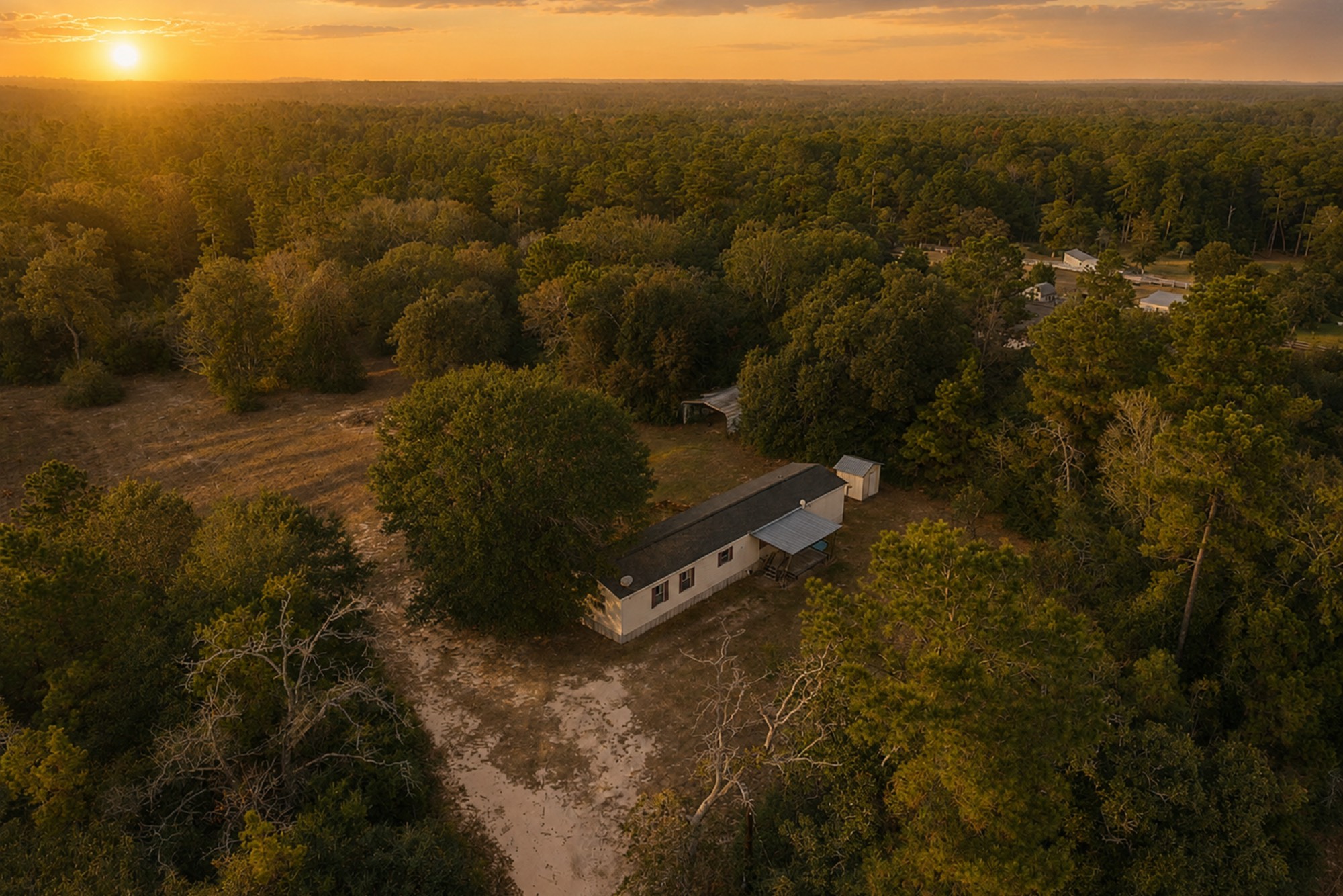 6493 Pappas Road Waller, TX 77484 - Photo 2 of 32 High-elevation sunset aerial capturing uninterrupted forest views and the expansive natural landscape surrounding 6493 Pappas Rd. This perspective underscores the long-term land value, minimal density, and the increasingly rare opportunity to own acreage within the growth path of the US-290 corridor.
