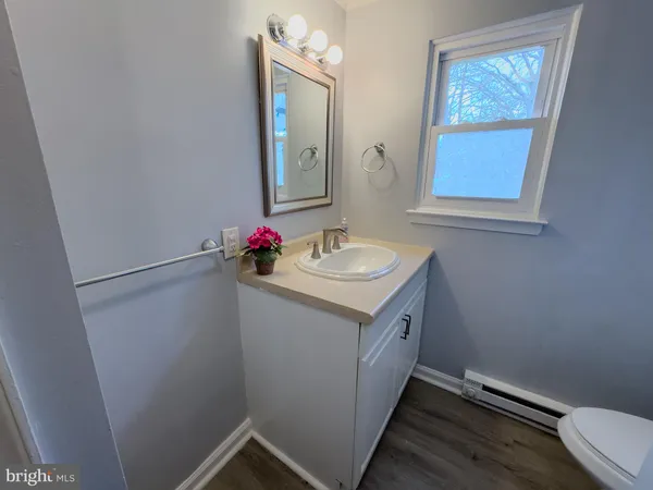 a white toilet sitting next to a bath tub