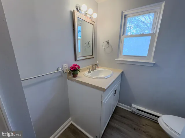 a white toilet sitting next to a bath tub