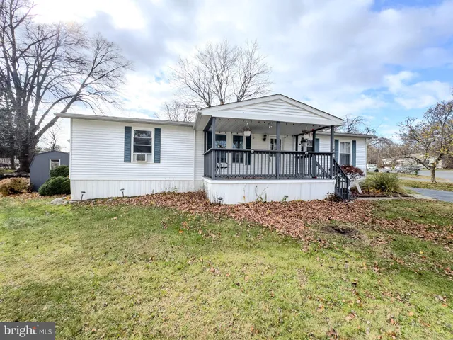 a house with green field in front of it