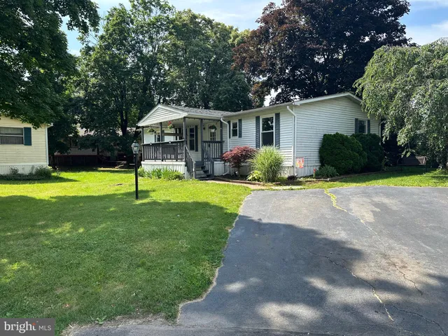 a view of a house with a swimming pool and a yard