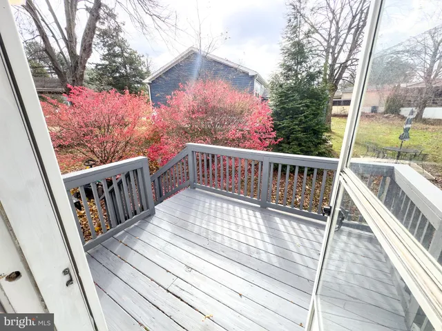 a view of an empty room with closet and a window