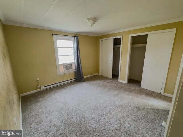 a view of an empty room with closet area
