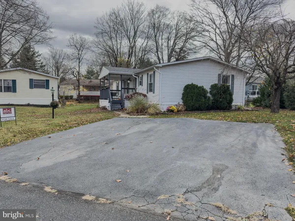 a view of a house with a yard covered in snow