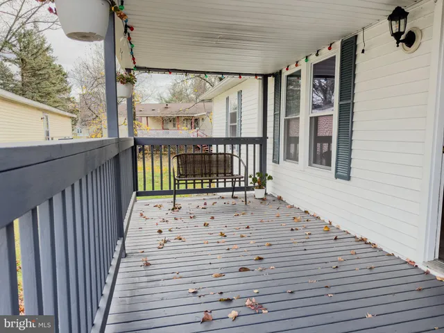 a view of a balcony with wooden floor