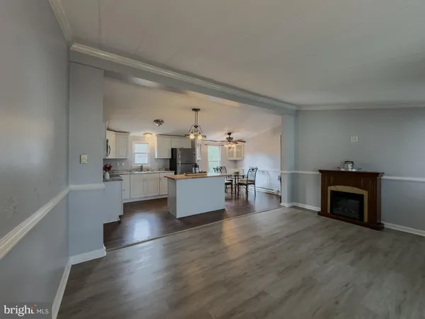 a view of kitchen with furniture and wooden floor