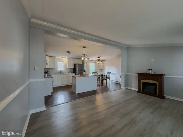a view of kitchen with furniture and wooden floor