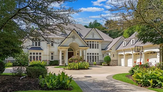 an aerial view of a house with swimming pool and garden