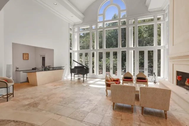 a spacious bedroom with a bed and a large window