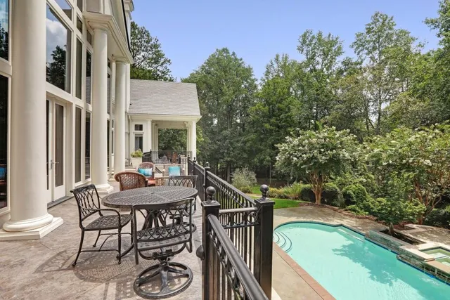 an aerial view of a house with a yard and lake view