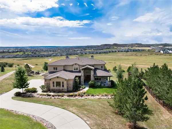 a aerial view of a house with a garden and lake view