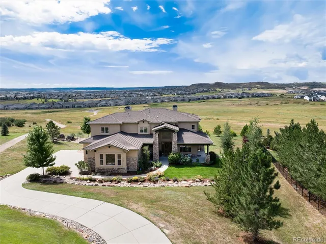 a aerial view of a house with a garden and lake view