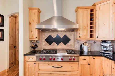 a kitchen with stainless steel appliances granite countertop a stove and a microwave
