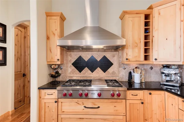 a kitchen with stainless steel appliances granite countertop a stove and a microwave