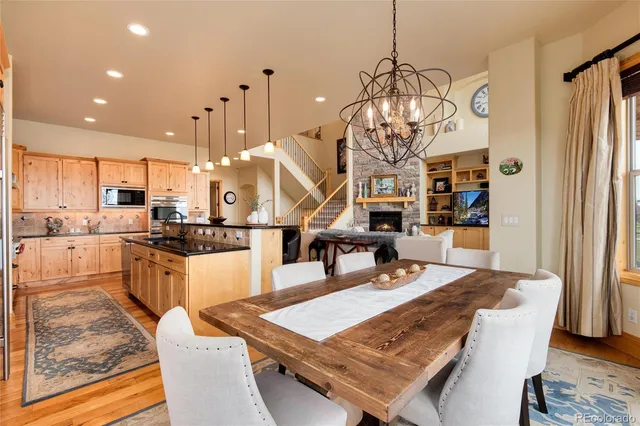 a large kitchen with a table and chairs