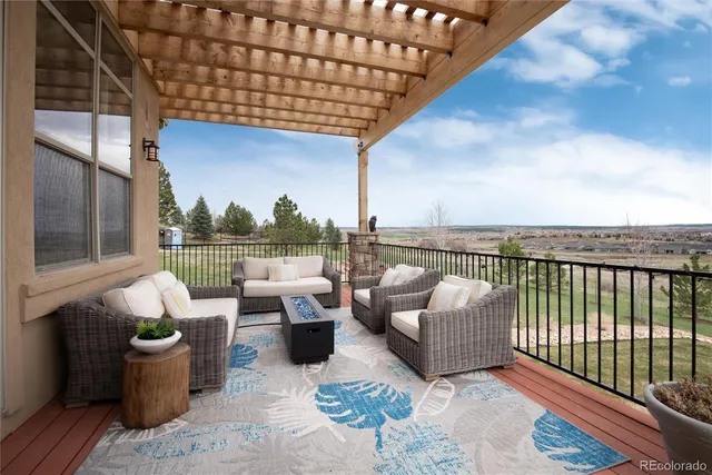 a balcony with couch and outdoor seating