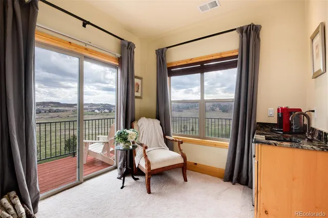 a living room with furniture and a floor to ceiling window