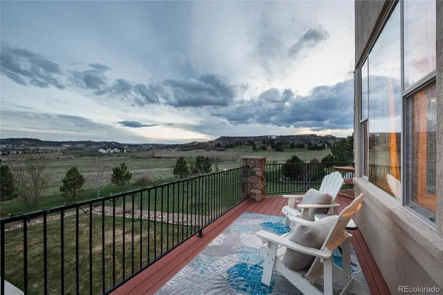 a view of a balcony with couches and wooden floor