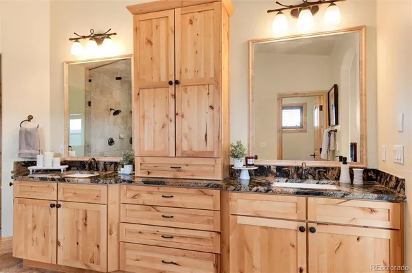 a bathroom with double sink and a mirror