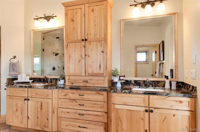 a bathroom with double sink and a mirror