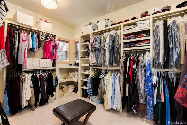a view of walk in closet with clothes