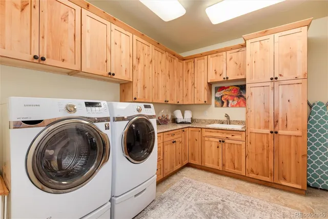 a utility room with sink dryer and washer