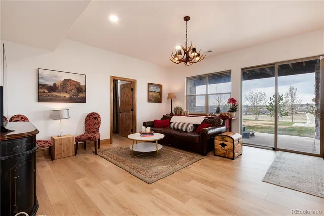 a living room with furniture a couch and a chandelier