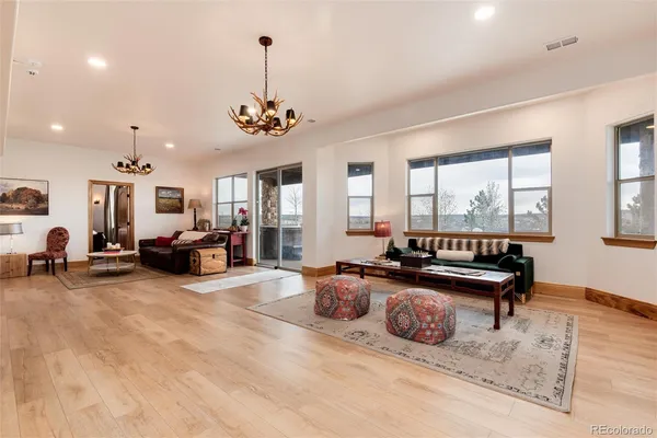 a living room with furniture flat screen tv and a large window