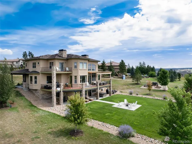 an aerial view of a house with swimming pool garden and balcony