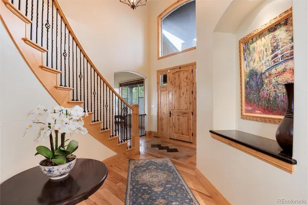 a living room with wooden floor and stairs