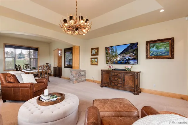 a living room with furniture a dining table and a flat screen tv