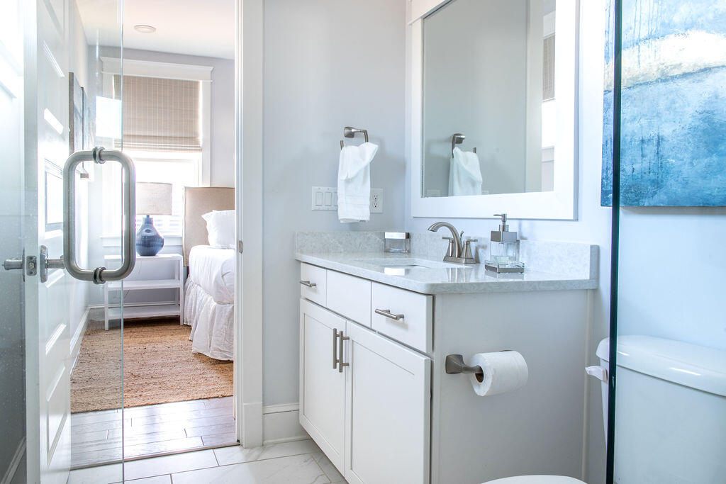 76 West Crabbing Hole Ln Inlet Beach Inlet Beach, FL 32461 - Photo 37 of 86 a bathroom with a sink a toilet and a mirror