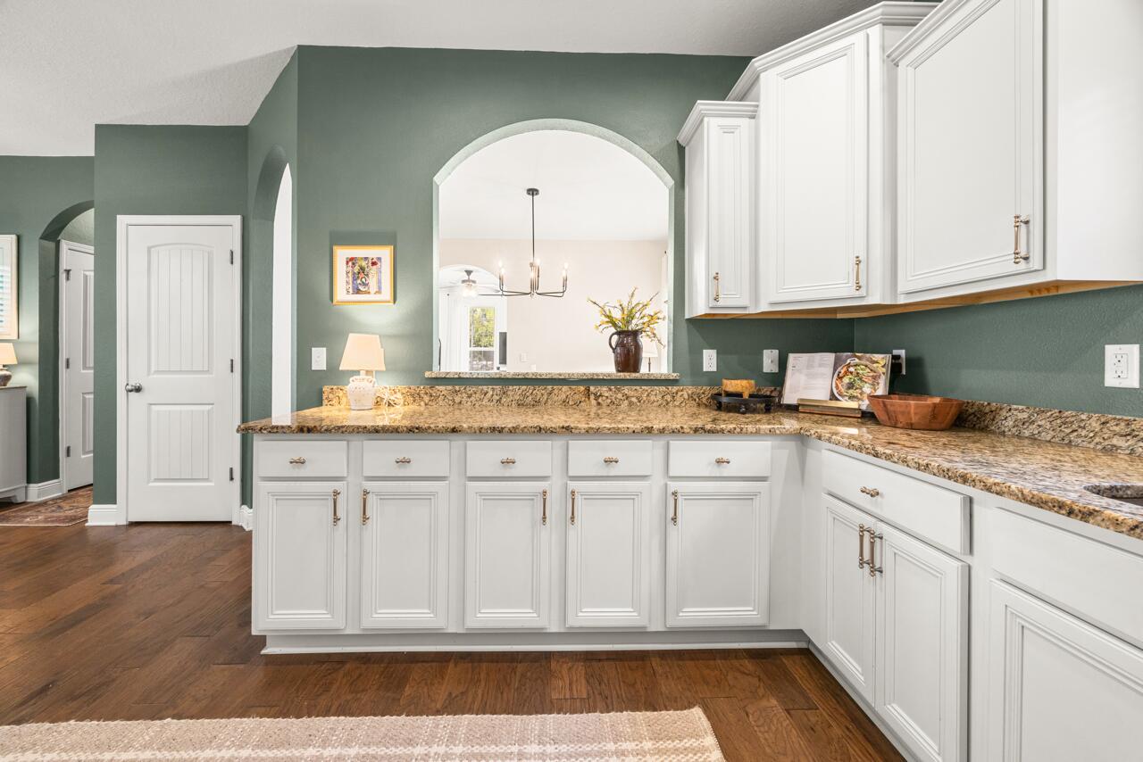 120 Mosaic Oaks Circle Santa Rosa Beach, FL 32459 - Photo 21 of 47 a kitchen with granite countertop white cabinets and white appliances
