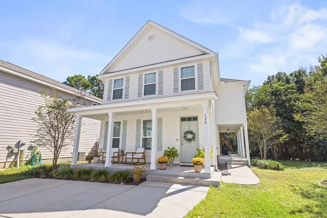a view of a house with backyard porch and sitting area