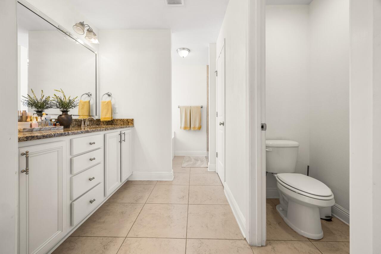 120 Mosaic Oaks Circle Santa Rosa Beach, FL 32459 - Photo 31 of 47 a bathroom with a granite countertop sink a toilet and a mirror