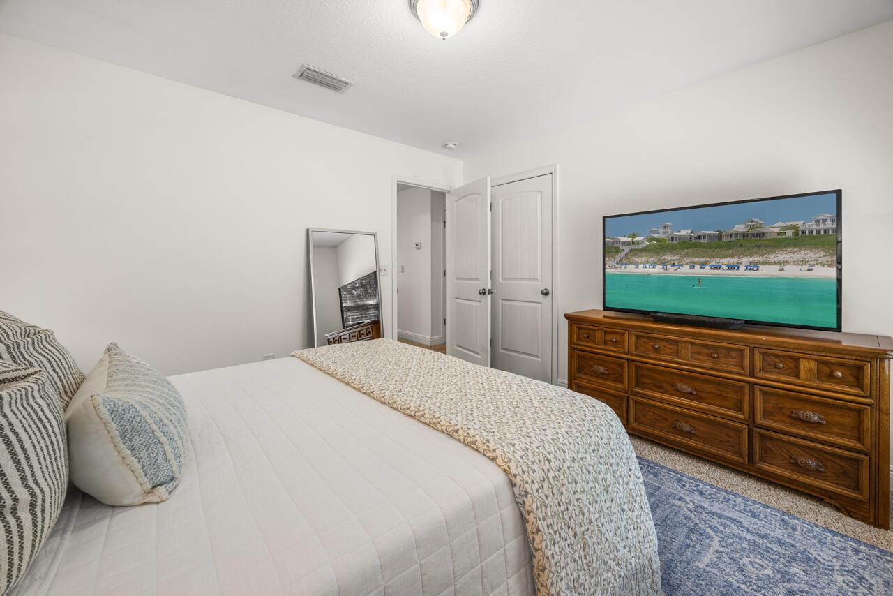 120 Mosaic Oaks Circle Santa Rosa Beach, FL 32459 - Photo 37 of 47 a bedroom with a bed and a flat screen tv