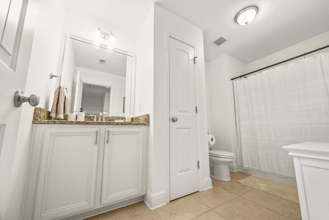 120 Mosaic Oaks Circle Santa Rosa Beach, FL 32459 - Photo 38 of 47 a bathroom with a granite countertop sink mirror and toilet