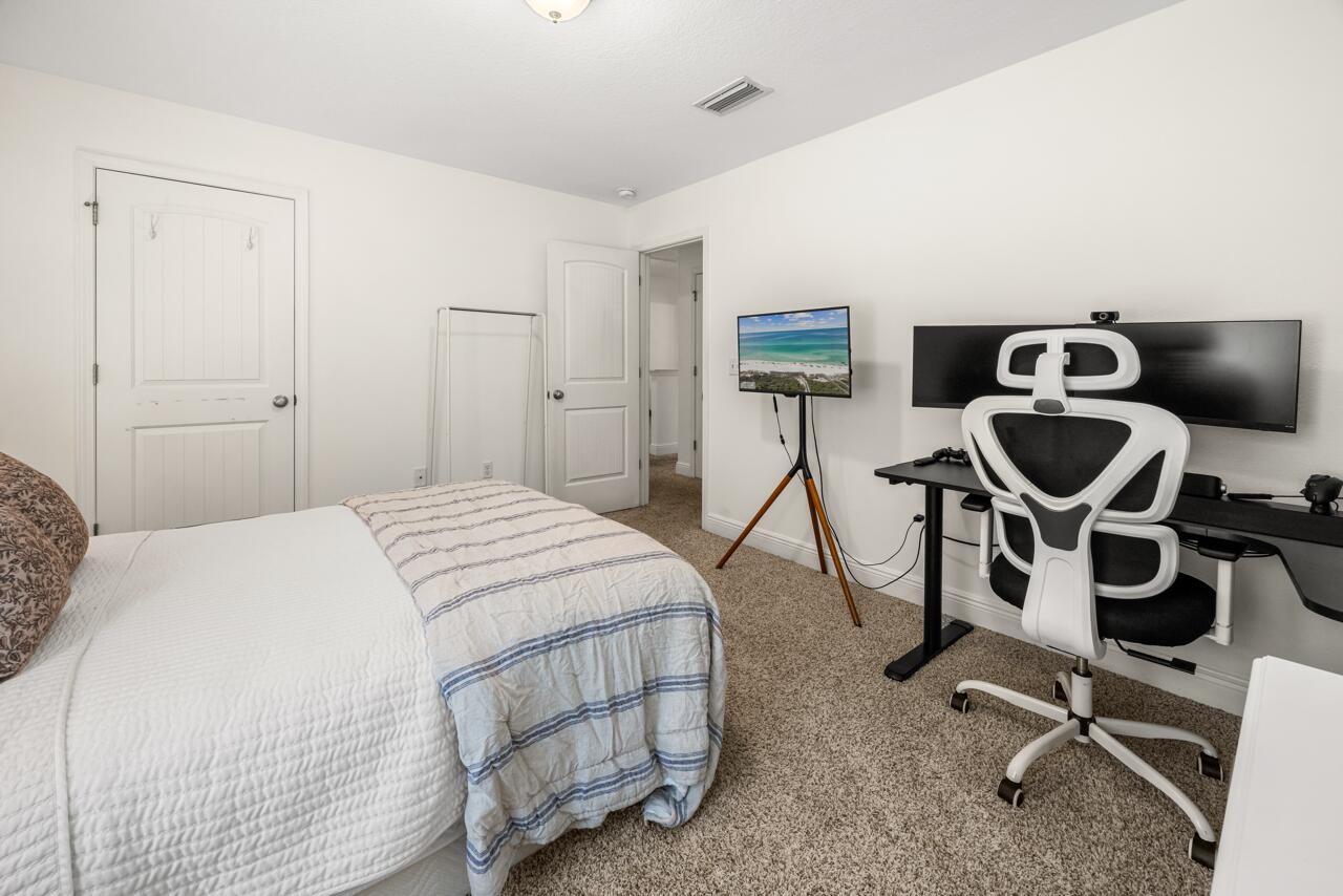 120 Mosaic Oaks Circle Santa Rosa Beach, FL 32459 - Photo 41 of 47 a bedroom with a bed and cabinets