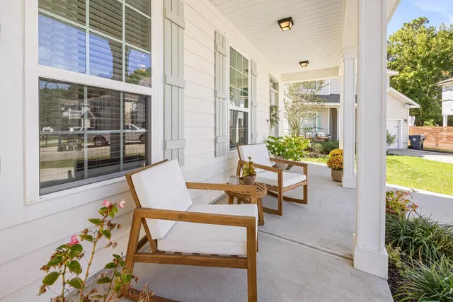 a view of a patio with table and chairs and potted plants