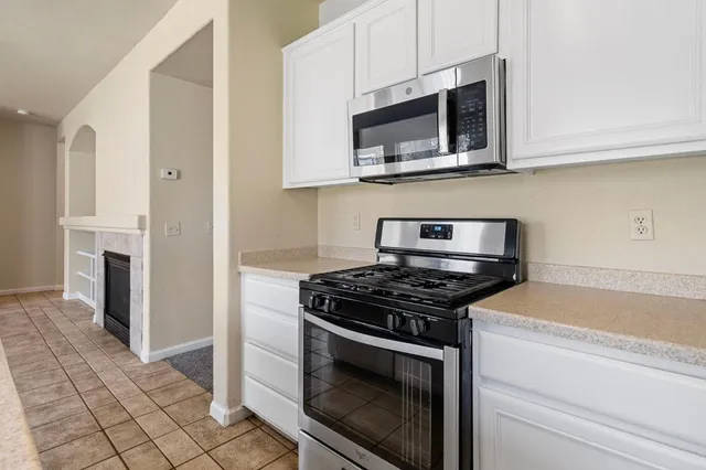 a view of a kitchen with furniture a ceiling fan and window