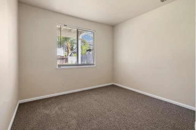 a view of a livingroom with a ceiling fan and window